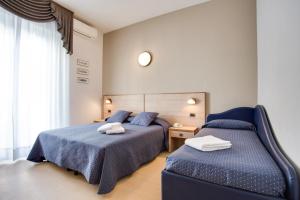 Postel nebo postele na pokoji v ubytování Hotel Villa dei Gerani