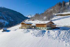 a house on top of a snow covered mountain at Biobauernhof Aslgut in Bad Hofgastein