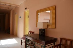 a room with a mirror and a table and chairs at Hotel Maya in Guadalajara