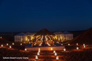a night view of a tent in the desert at Sahara Desert Luxury Camp in Merzouga