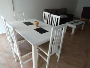 a white table and chairs in a living room at Piso Almería playa in Almería