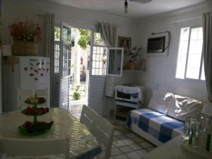 a living room with a table and a bed at Chalé 01 em Maragogi Brasil Maragogi in Maragogi +9 photos
