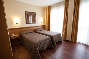 Ένα ή περισσότερα κρεβάτια σε δωμάτιο στο Hotel Esperia