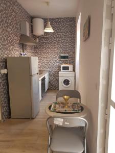 eine kleine Küche mit einem Tisch und einem Kühlschrank in der Unterkunft Estudio 54 Centro in Alicante