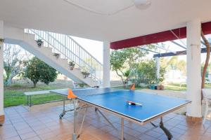 a ping pong table on a patio with a staircase at Villa Lago Sol in Torrevieja