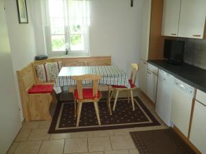 una pequeña cocina con mesa y 2 sillas en Weinbergstöckl Gombotz en Neuhaus am Klausenbach