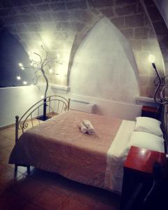 a bedroom with a bed with a stuffed animal on it at Casa Vacanza Bella Vista in Matera
