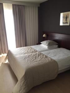 Postel nebo postele na pokoji v ubytování Hotel Prélude