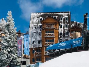 a building with a sign on the side of it at Apartment 533 at Aparthotel Vucko Jahorina in Jahorina