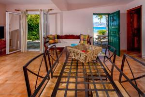 a living room with a table and chairs at Zakynthos Seascape in Lithakia