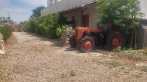 an old tractor parked next to a building at Masseria Fachechi in Nardò