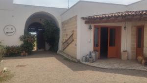 a house with a smiley face painted on the side of it at Masseria Fachechi in Nardò