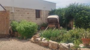 an old rv parked in a garden next to a building at Masseria Fachechi in Nardò
