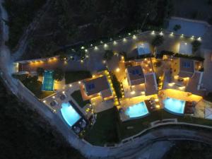 an aerial view of a house at night with lights at Thea Thalatta Villas in Tsoukaladhes