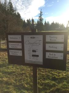 a sign for a tasting room and a field at Comforts of Whidbey in Langley