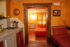 a kitchen with a stove and a couch in a room at L'Angolo Di Verlano in Canossa