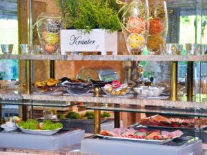 a buffet of food on display in a restaurant at Hotel Quellenhof in Bad Wiessee