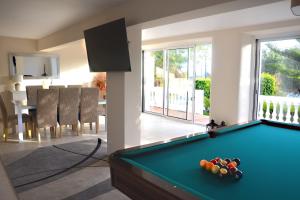 a room with a pool table in a house at Villa on the Beach by GalanteVasques in Carvoeiro