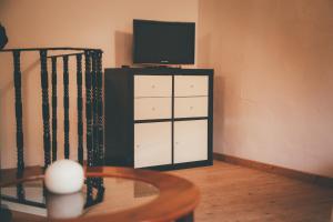 a tv sitting on top of a cabinet with a television at La Guaxa, casina a 900 m de la playa de Poo VV-1371-AS in Llanes
