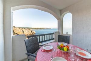 a table with a bowl of fruit on a balcony at Apartment Lucia in L'Escala