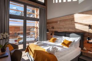 a bedroom with a bed and a large window at 22 Summits Boutique Hotel in Zermatt