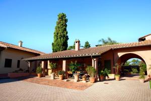 a house with a courtyard with potted plants on it at Assia Spa in Fucecchio