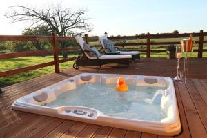 a bath tub with a rubber duck in it on a deck at The Orchard Bramble Lodge in Hadleigh