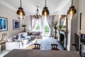 a living room with a couch and a table at Court House Apartment in Cheltenham