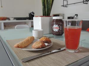 a table with a plate of food and a drink at Casa Anna in Ilbono