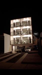 a building with a car parked in front of it at night at Pichilemu Surf Hotel in Pichilemu