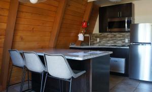 a kitchen with a counter with chairs and a refrigerator at Red Agave Resort in Sedona