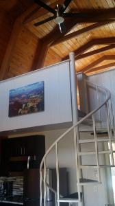a staircase in a house with a painting on the wall at Red Agave Resort in Sedona