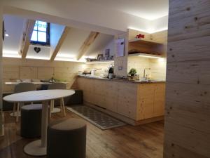 a kitchen with a table and chairs and a counter at B&B Schlossar Haus in Sappada +20 photos