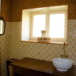 a bathroom with a sink and a window at Countryhouse La Rose in Les Thons