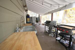 a kitchen with a sink and a grill in a tent at Goldberry Woods- A Modern Farm Resort in Union Pier