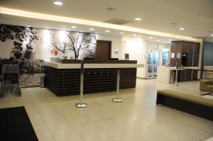 a lobby with a reception desk in a building at Lizz Hotel in Uberlândia