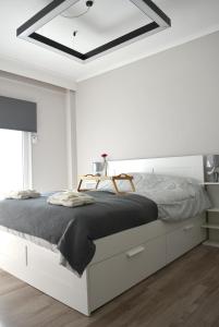 a white bedroom with a large bed with white cabinets at Chic & Cozy Apartment in Thessaloniki