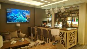 a bar with a couch and a table in a room at Armenia in Nerkʼin Giratʼagh