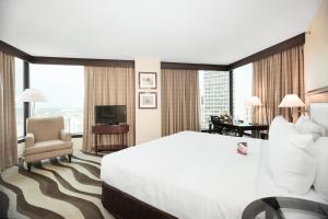 a hotel room with a large bed and a television at Fort Pontchartrain Detroit, a Wyndham Hotel in Detroit