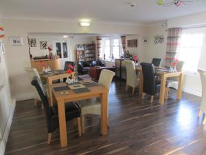 a dining room and living room with a table and chairs at The Southgate B&B in Filey