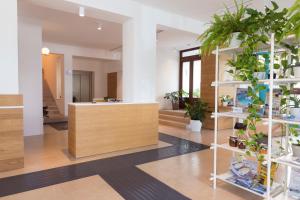a lobby with potted plants and a counter at Residence Itaca in Castellammare del Golfo