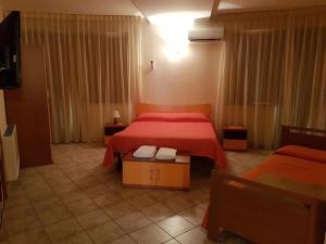 Llit o llits en una habitació de Hotel Il Baronetto