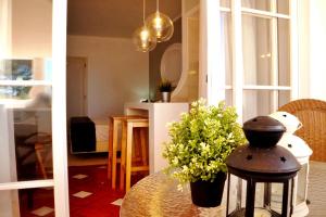 a living room with a table with a plant on it at Baluarte da Vila Apartments in Lagos