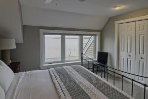 a bedroom with a bed and a desk and a window at 312 Water Street Inn in Boyne City