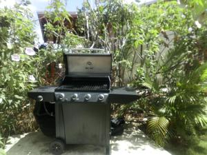 a laptop computer sitting on a table in a garden at The Pool House in Saint Philip