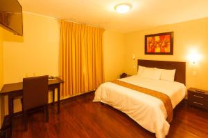 a hotel room with a bed and a desk at Casa Suyay in Lima