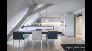 a kitchen and dining room with a table and chairs at Luxury Penthouse Apartment in Zürich