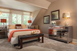 a bedroom with a bed and a table at Gothic Eves Inn and Spa Bed and Breakfast in Trumansburg