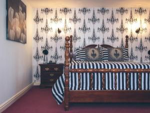 a bedroom with a bed with black and white pillows at The Bell Hotel in Winslow