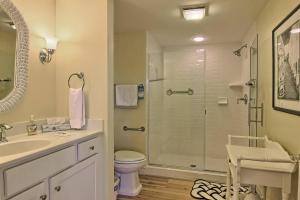a bathroom with a shower and a toilet and a sink at 115 Water Street Inn in Boyne City